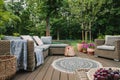 Garden patio decorated with wicker sofa and coffee table