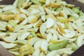 Garden pears, cut into wedges, for drying. Pear background. Green and yellow.