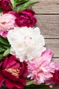 Garden peony flowers on wood