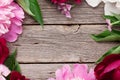 Garden peony flowers on wood