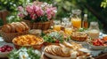 A garden picnic setup for Easter breakfast, including sandwiches, quiches, fresh salads, bread and different beverages Royalty Free Stock Photo