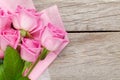 Garden pink roses bouquet over wooden table