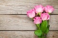 Garden pink roses bouquet over wooden table