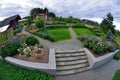 Garden plot with a house, flowerbeds and paving