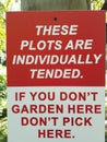 garden plots individually tended sign red and white