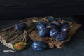 Garden plums on the table. Autumn harvest. Blue plums. Fresh plums on a wooden surface. Fresh plums on a wooden table background. Royalty Free Stock Photo