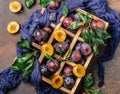 Garden plums on table. Close up of fresh plums with leaves. Autumn harvest of plums. Royalty Free Stock Photo