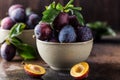 Garden plums on table. Close up of fresh plums with leaves. Autumn harvest of plums. Royalty Free Stock Photo