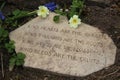 Garden poem on stone with primroses kindness concept Royalty Free Stock Photo