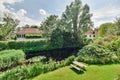 a garden with a pond and a picnic bench