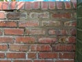 Garden red brick wall with old and new mortar. Royalty Free Stock Photo