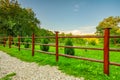 Garden red wooden fence and green grass