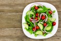 Garden salad on plate with wood background Royalty Free Stock Photo