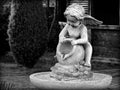 Garden sculpture of an angel pouring water Royalty Free Stock Photo