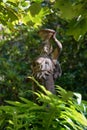 Garden sculpture of woman with jug. Summer garden decoration statue Royalty Free Stock Photo