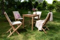 Garden seating group garden table spring scene colourful plant country breakfast in the garden.