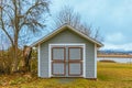 Garden shed front. Gardening tools shed. Garden house, wooden tool-shed. Single-story roofed structure in a back garden Royalty Free Stock Photo