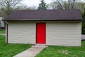 Garden shed green grass door red storage barn Royalty Free Stock Photo