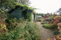 Garden shed and greenhouse surrounded by a beautiful decorative Royalty Free Stock Photo