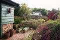 Garden shed and greenhouse surrounded by a beautiful decorative Royalty Free Stock Photo