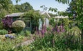 Garden shed surrounded by a beautiful decorative garden