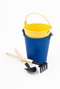 Garden shovel, rake and blue metal bucket isolated Royalty Free Stock Photo