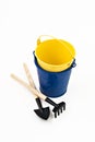 Garden shovel, rake and blue metal bucket isolated Royalty Free Stock Photo