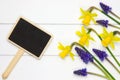 Garden sign on wooden surface and spring flowers Royalty Free Stock Photo