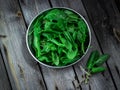 Garden sorrel in a bowl on wooden table. Style rustic. . Royalty Free Stock Photo
