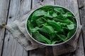 Garden sorrel in a bowl on wooden table. Style rustic. . Royalty Free Stock Photo