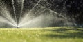 Garden sprinklers on green grass Royalty Free Stock Photo