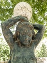garden statue.  child figure with lamp globe on his head.  dirty with cobwebs. Royalty Free Stock Photo