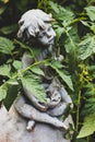 Garden statue with green tomato vines Royalty Free Stock Photo