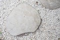 GARDEN STONE PATH. Dry leaf texture on white stone for footpath in rock garden hardscape