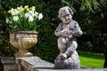 Garden stone sculpture of a boy playing mandolin in the Hatley Castle Park