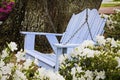 Relaxing wooden blue swing with azaleas