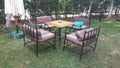 Garden table with iron chairs and sun umbrellas