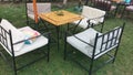 Garden table with iron chairs and sun umbrellas