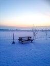 Garden table in snowy sunset in Sweden Royalty Free Stock Photo
