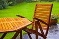 Garden table stands in the rain Royalty Free Stock Photo