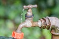 Garden tap with dropping water against blurry background Royalty Free Stock Photo