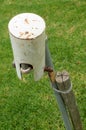 A garden tap with a metal hat Royalty Free Stock Photo