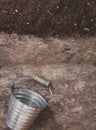 A garden tool, a bucket on a wooden old brown table, close-up. C Royalty Free Stock Photo