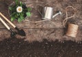 Garden tool, shovel, rake, watering can, bucket, tablets for plants, flower daisy in a flowerpot on a wooden old brown table with Royalty Free Stock Photo