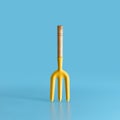 Garden tool. Yellow fork on blue background