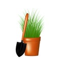 Garden trowel and grass in flowerpot