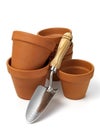 Garden trowel and terracotta pots on a white Royalty Free Stock Photo