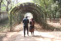 a garden tunnel with flower plant and couple