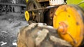 Garden walk-behind tractor close-up on a black and white background. Yellow pulley with belt drive for torque transmission. Wheel Royalty Free Stock Photo