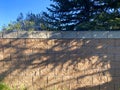 Garden wall sunny shadows shade tree shadow trees brick block landscaping barrier Royalty Free Stock Photo